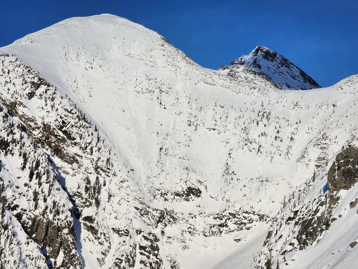 View of a bold skintrack across the entire face of MacD W Shoulder, as well as numerous wet loose slides.