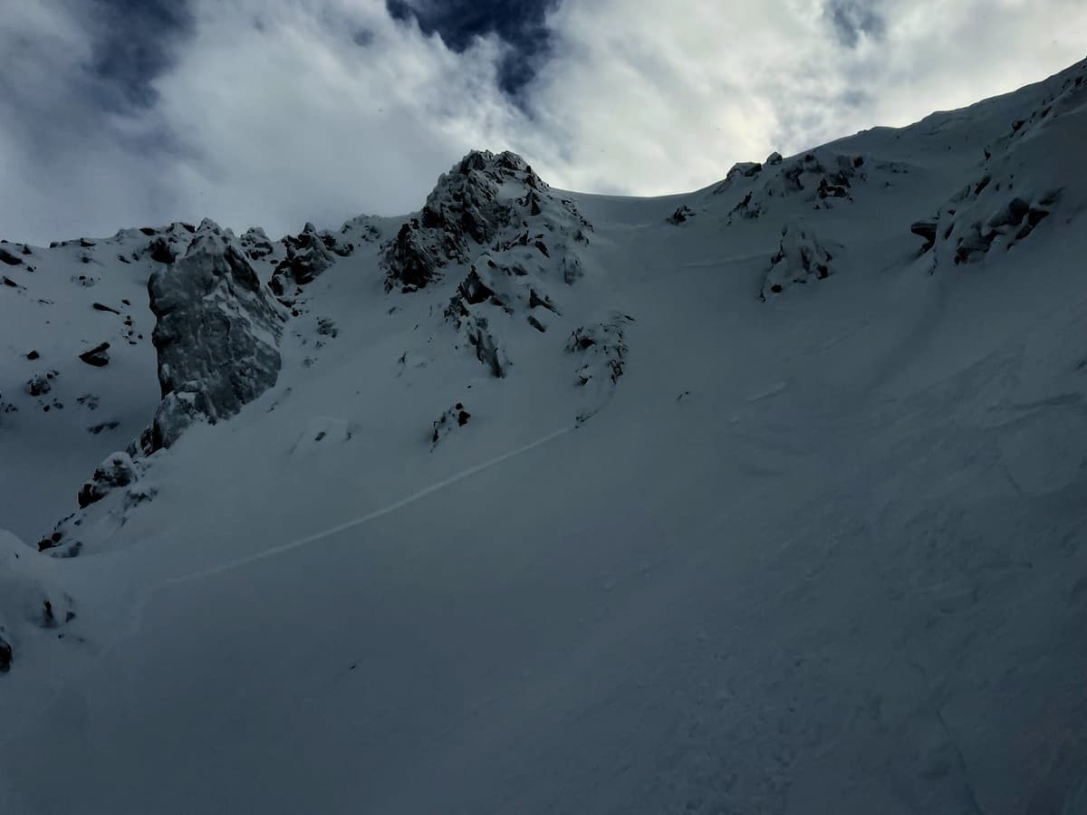 Crown and tracks from safe spot in couloir.