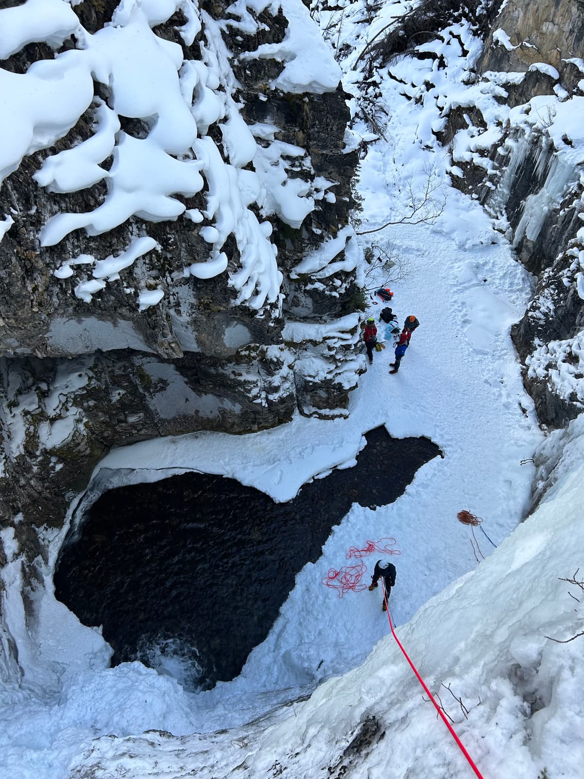 Snow opposite of belay station, had consistently slugging snow, which was heavy and posed a danger to those in the area.