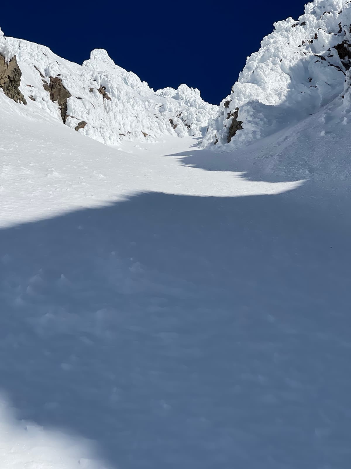 Midway through bootpack. Line continues through dog leg  going up and right onto upper snowfield.