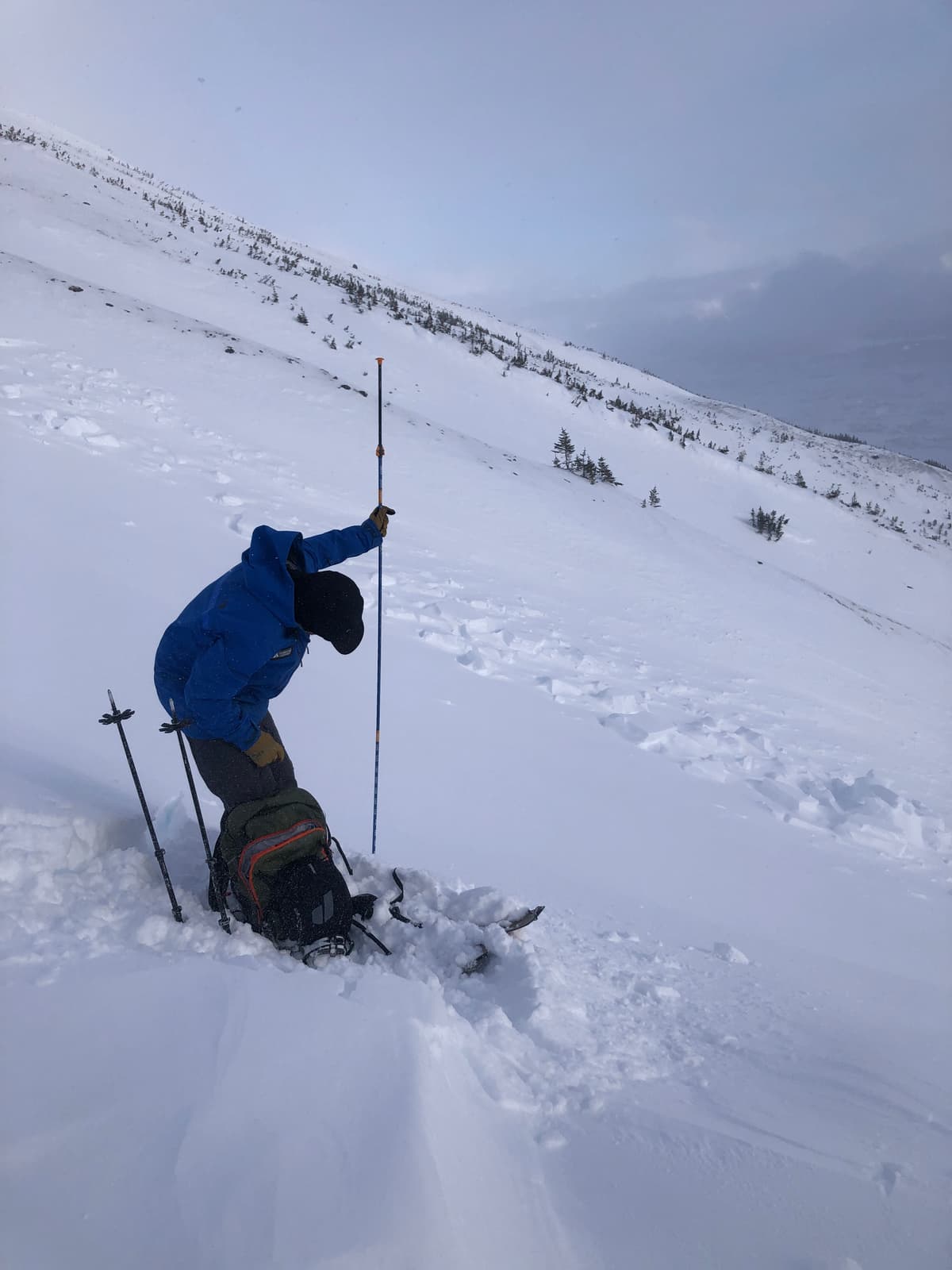 Probing the depth of newly wind-deposited storm snow adjacent to the Sz 2 slide on the south end of Fraser Chutes (sled chutes)