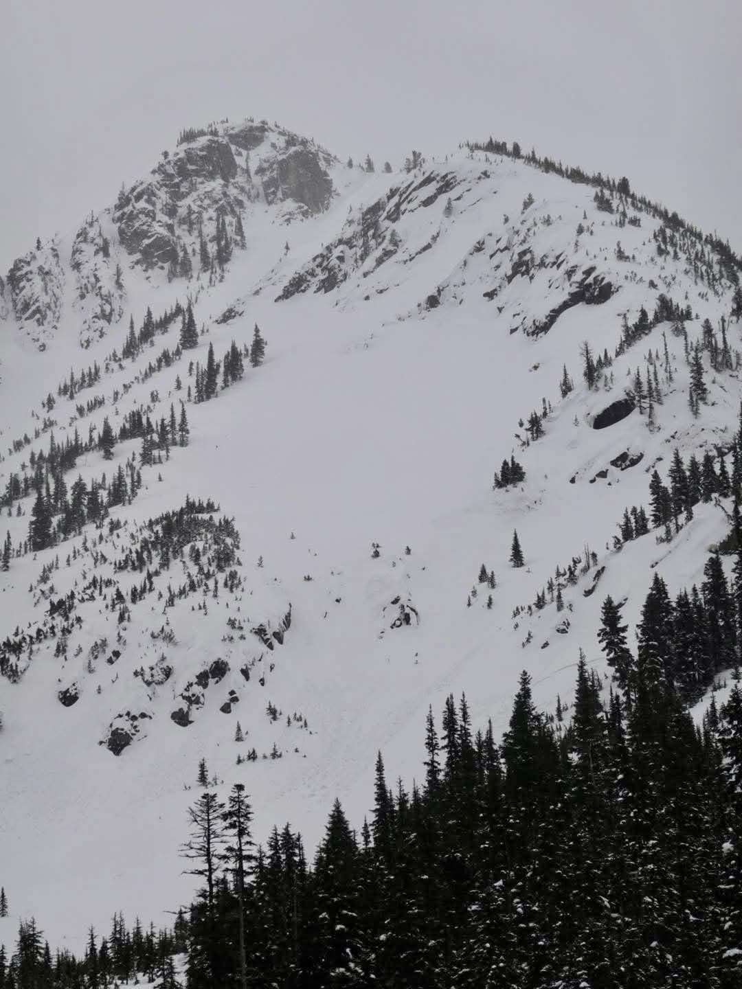 Crown can be seen semi-hidden behind the tip of the trees at the bottom centre of the image.