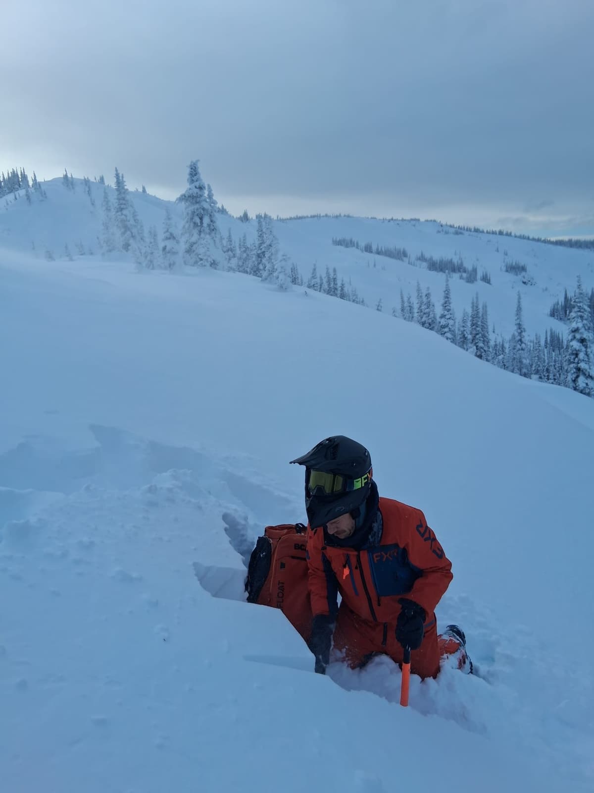 checking out the wind slab in a small drift just below the ridge line. 