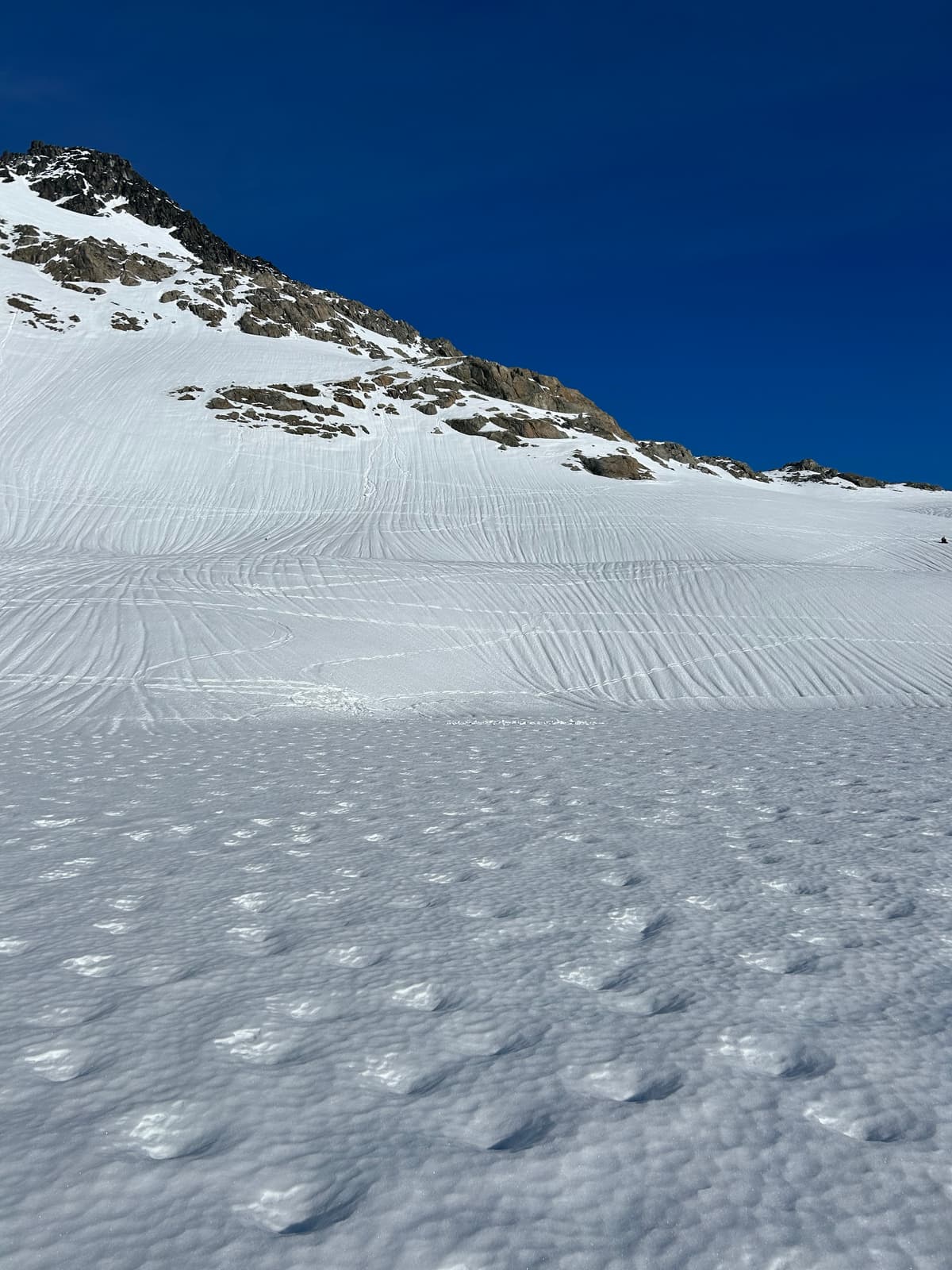 Photo from Circle Lake shows widespread melt-freeze crust with circular surface depressions under sunny conditions