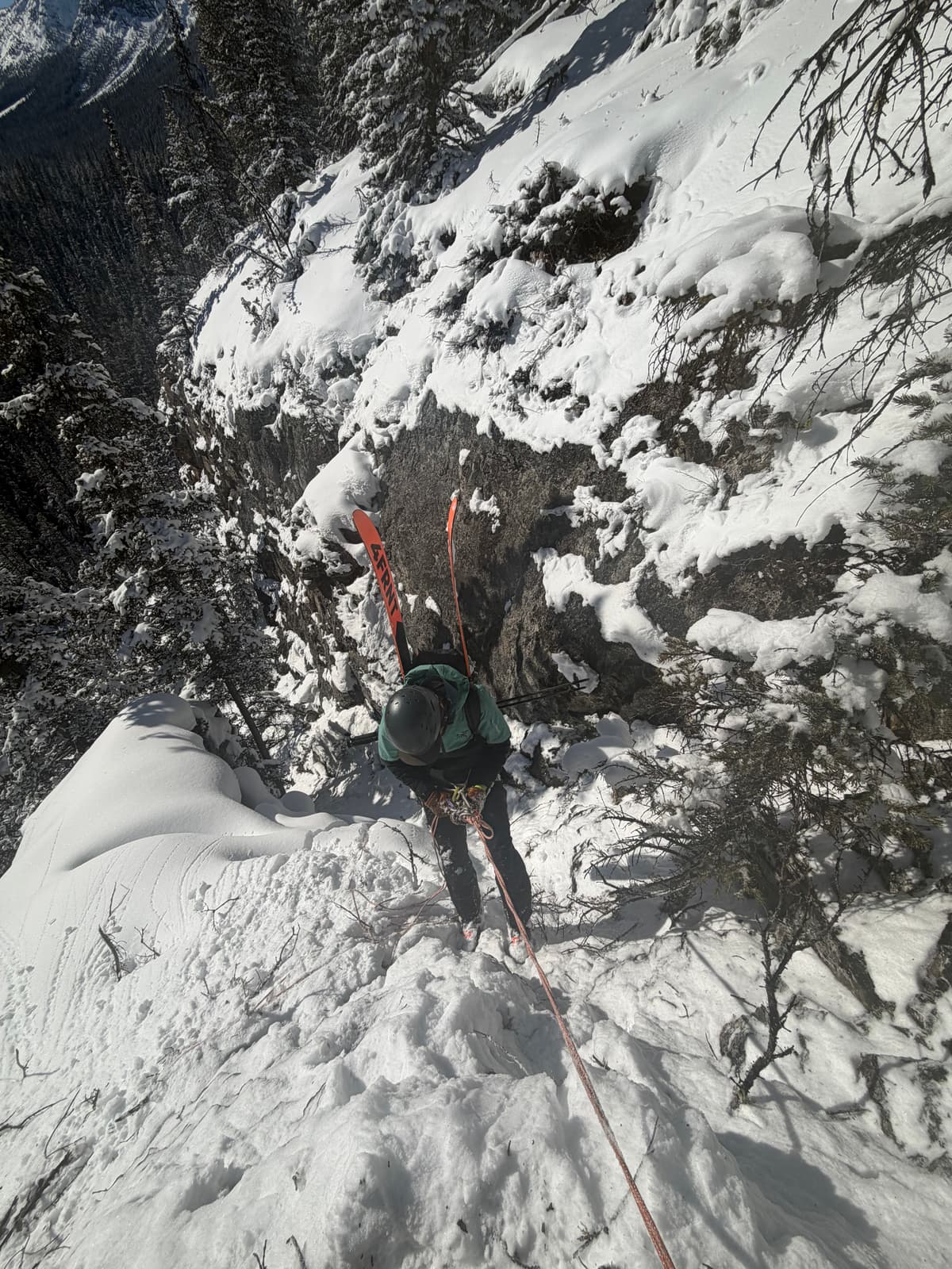 Rappel 15m to traverse hard left under Clift band and ski back to car park 