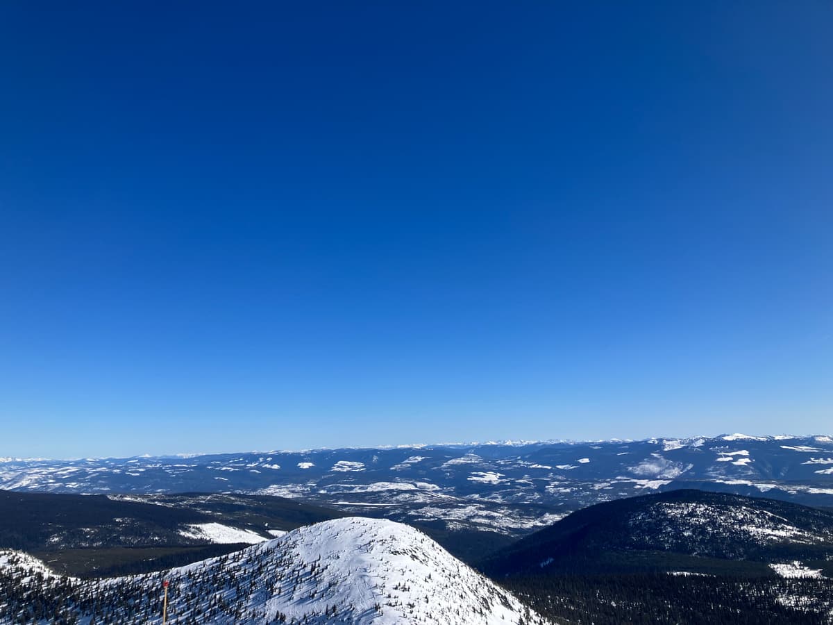 Snow is sun affected on the south side of east peak