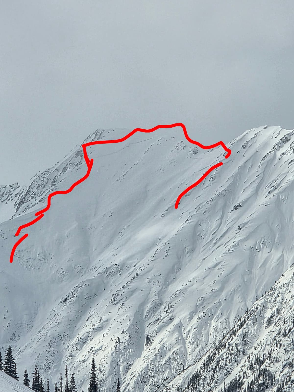 Line drawn above crown. Crown estimated to be 100+cm thick on lockers left, and propagates across central rib into a more windslab looking crown but the entire face failed. Could not see debris expected to be size 3-3.5