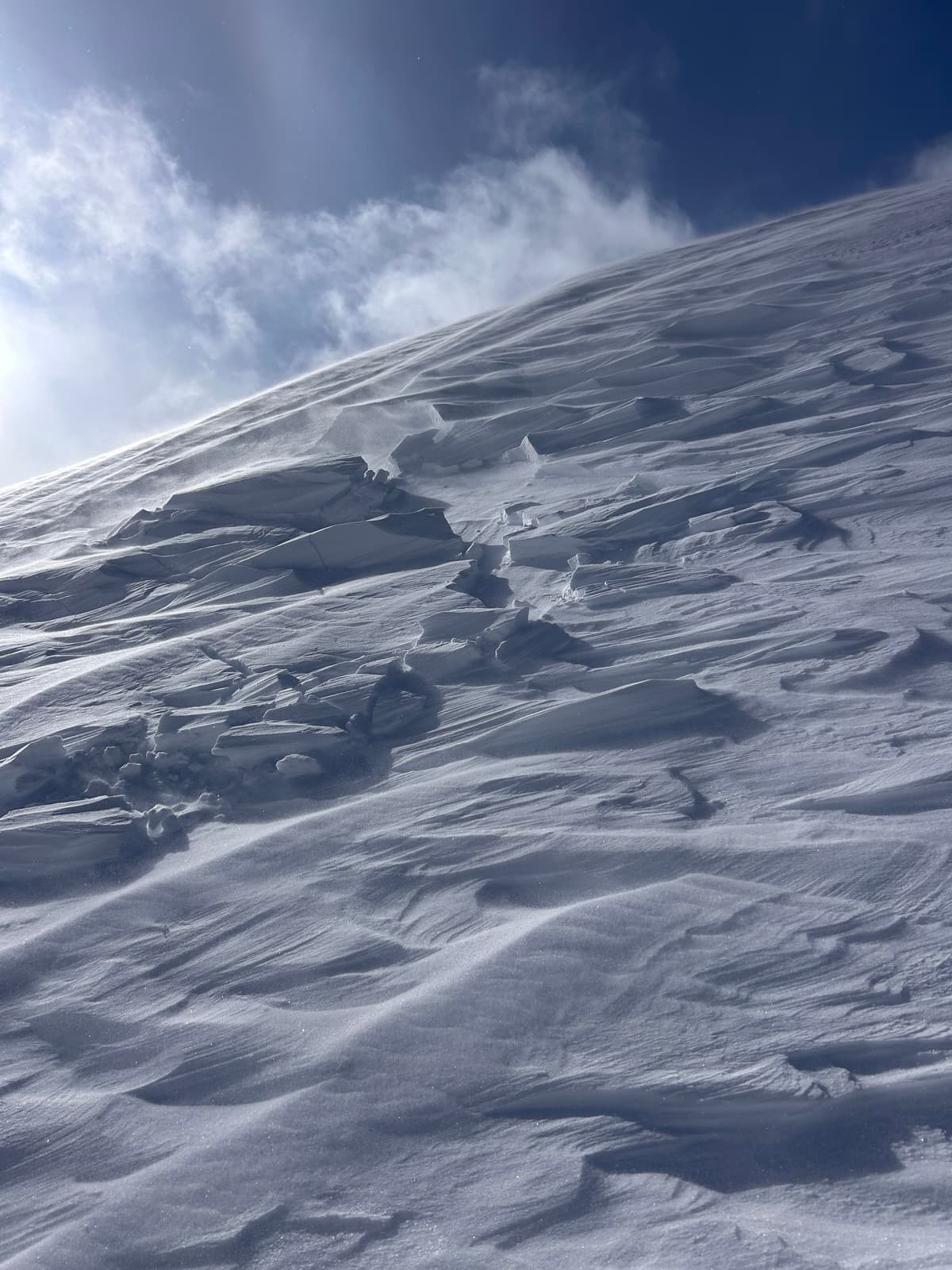 Hard wind slab forming at ridge crest from strong north easterly winds.