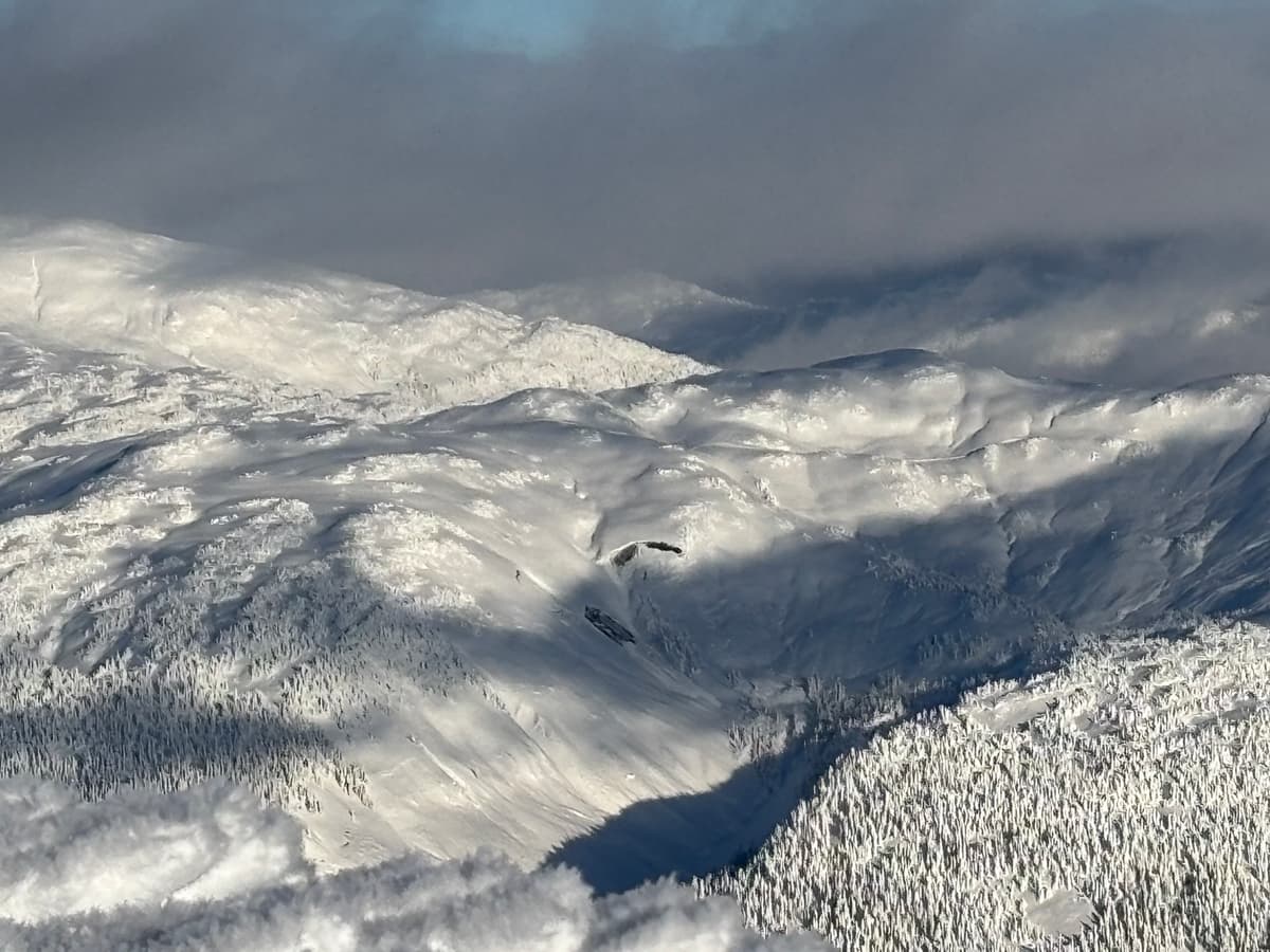 Glide crack and avalanche that appears to have failed down to the ground visible to the west on a south west face.
