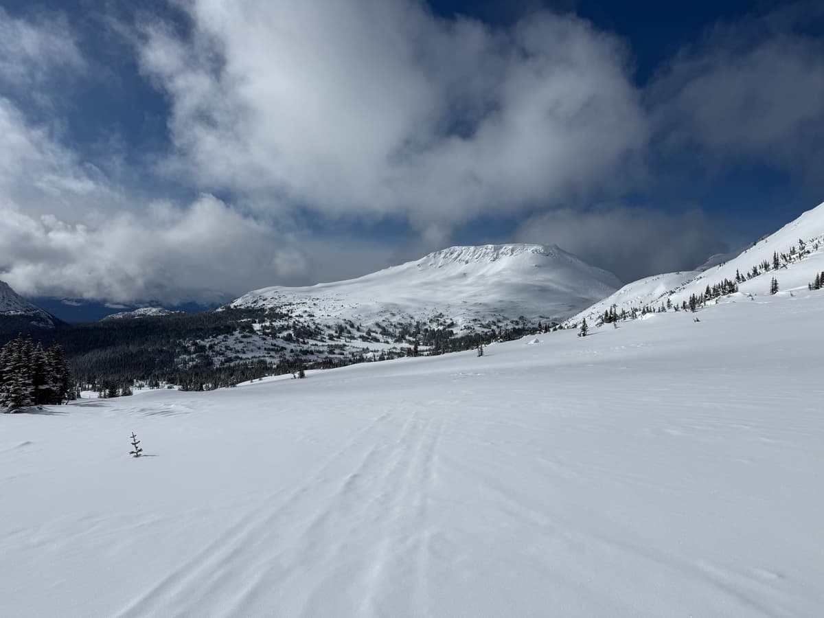 Ridglines held cornices in the lee and some wind slab debris was visible through newer snow on the surface.