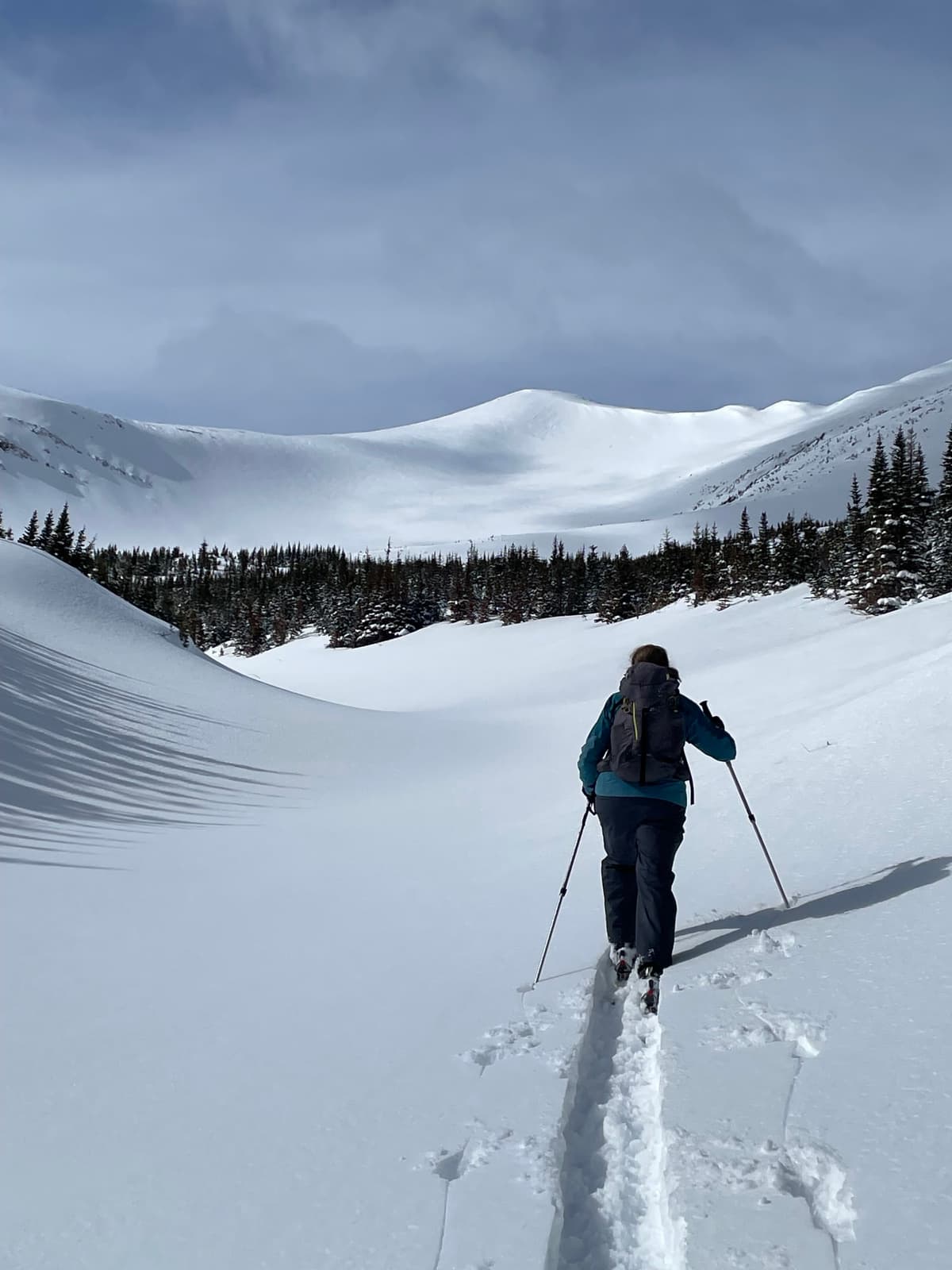 Deep new snow in the creek valley approach.
